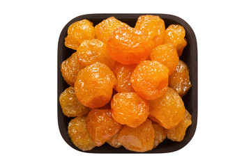 candied fruit, paradise apple in square bowl isolated on white background. organic food, top view.