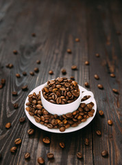 White cup and dish with coffee beans.