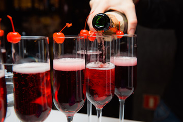 The waiter pours champagne.