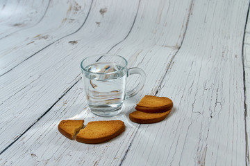 A bottle of water, crackers, drying on the background of boards for a healthy lifestyle.