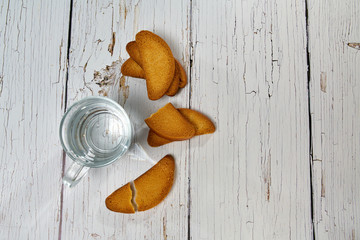 A bottle of water, crackers, drying on the background of boards for a healthy lifestyle.