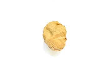 A crumpled ball of yellow craft paper on a white background and a shadow.