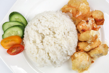 Butter Chicken Rice deep fried boneless chicken cube topped with sweet butter sauce with white rice cucumber and tomato slice