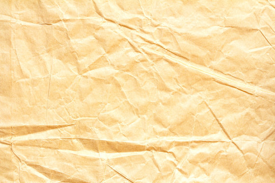 Background Of Crumpled Yellow Craft Paper With Space For Writing.