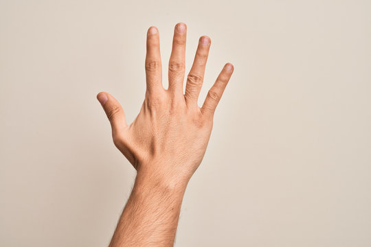 Hand of caucasian young man showing fingers over isolated white background counting number 5 showing five fingers