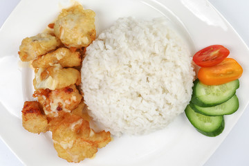 Butter Chicken Rice deep fried boneless chicken cube topped with sweet butter sauce with white rice cucumber and tomato slice