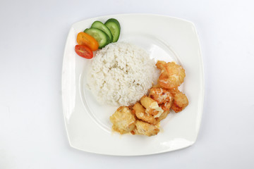 Butter Chicken Rice deep fried boneless chicken cube topped with sweet butter sauce with white rice cucumber and tomato slice