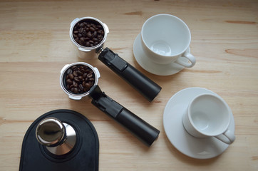 Filter holder and coffee beans with white coffee cup.