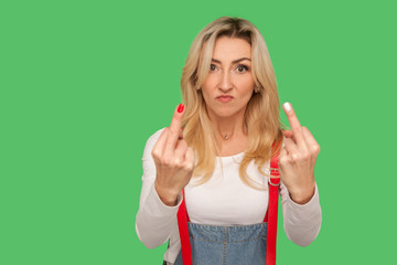 Portrait of angry impolite rude woman in denim overalls rejecting communication, showing double...