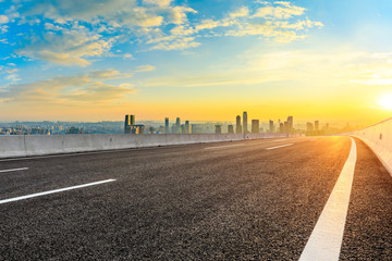 Fototapeta premium Empty asphalt road and Chongqing city skyline and buildings at sunset,China.