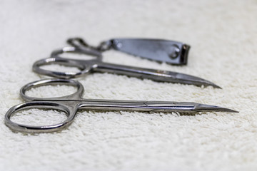 manicure instruments for nail care, nail clippers and nail scissors on white towel - Image