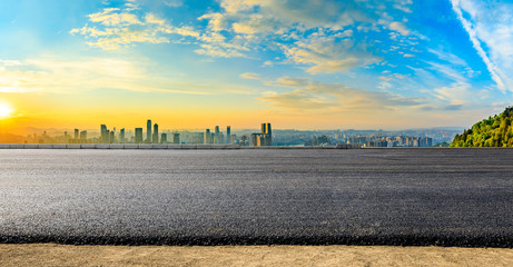 Fototapeta na wymiar Empty asphalt road and Chongqing city skyline and buildings at sunset,China.