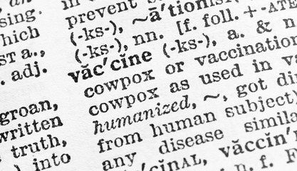Vaccine - Closeup macro of English dictionary page with word vaccine