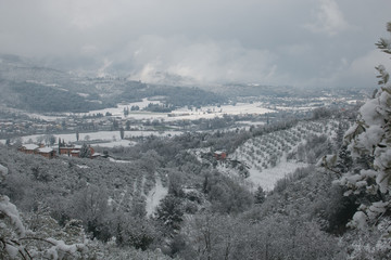 Spring landscape of Foligno with snow during cloudy day