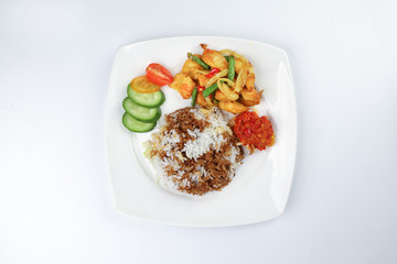 Turmeric Friend Chicken with vegetable white rice topped with dark sauce ayam goreng kunyit