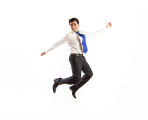 Young office corporate man jumping high spreading his arms with joy wearing blue tie isolated on a white background