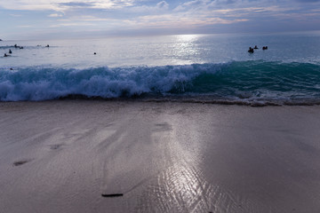 Surfing on the island of Bali in the Pacific and Indian Ocean. Male surfers engage in active sports on sick waves