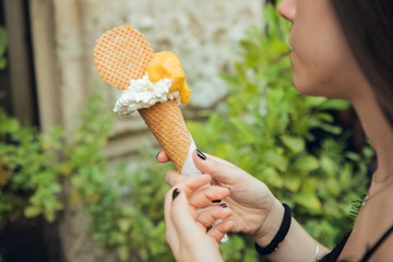 Portrait of brunette girl with lemon and vanilla ice cream in summer