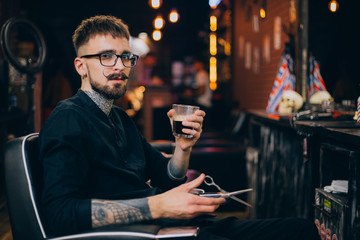 barbershop. portrait of a moustachioed barbershop master in the workplace