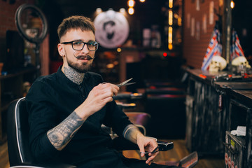 barbershop. portrait of a moustachioed barbershop master in the workplace