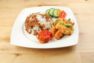 Turmeric Friend Chicken with vegetable white rice topped with dark sauce ayam goreng kunyit