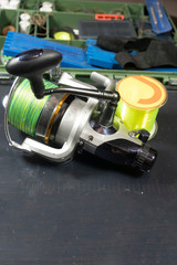 Fishing equipment on a old wooden table. Sport and recreation concept