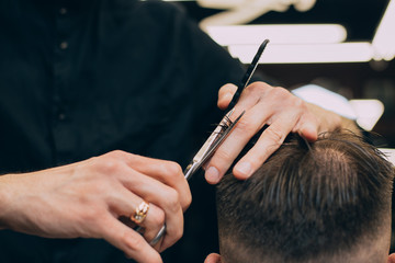 straight razor, brush for shaving beard along with bowl, blurred background of hair salon for men, barber shop