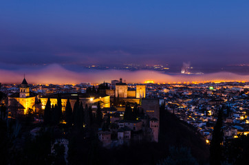 View of the Alhambra and the Generalife and the city of Granada from the viewpoint of the Silla del Moro at sunrise.