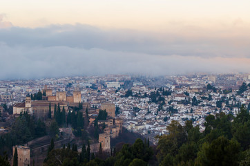 Fototapeta premium View of the Alhambra and the Generalife and the city of Granada from the viewpoint of the Silla del Moro at sunrise.