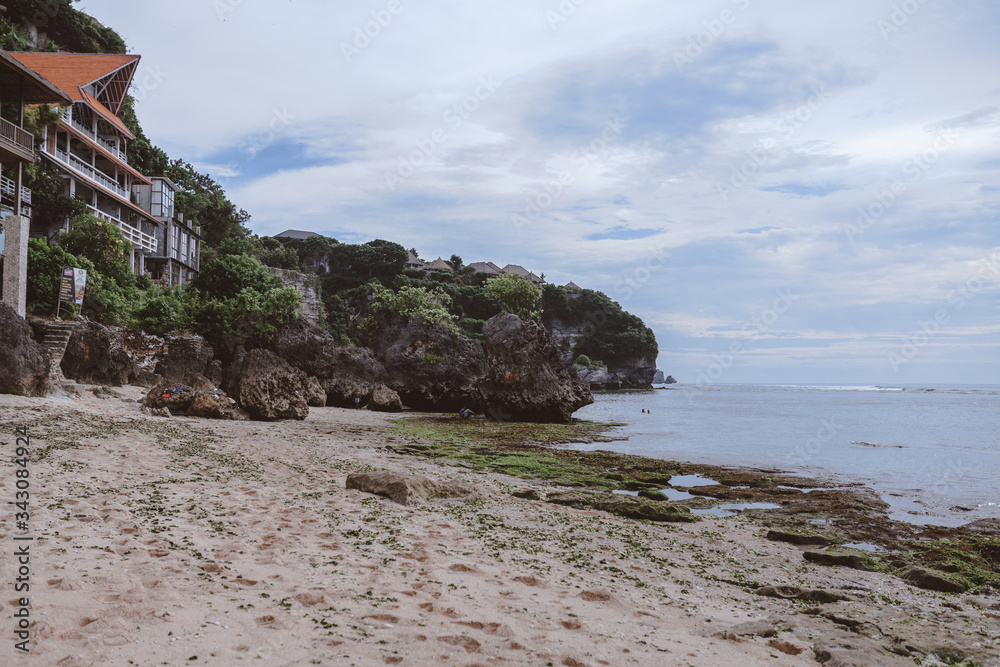 Canvas Prints beautiful deserted beach on the island of bali at sunset. rocks and nature. plants and houses on the