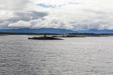 Small islands with lighthouse in the Norwegian fjords. selective focus