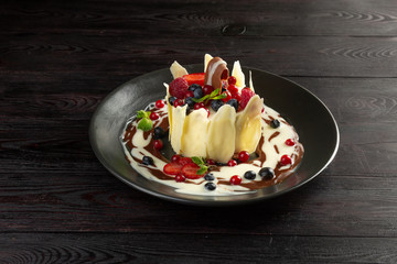 milk dessert with fruit and chocolate on a dark background