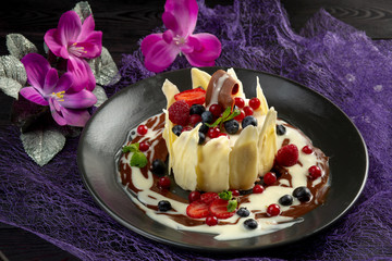 milk dessert with fruit and chocolate on a dark background