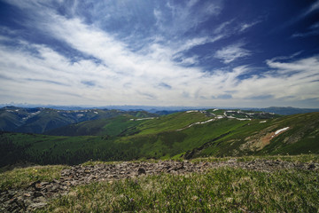 Fototapeta premium Spectacular view from the top of the mountain to the mountain slopes and meadows in the Ulagansky District of the Altai republic, Russia