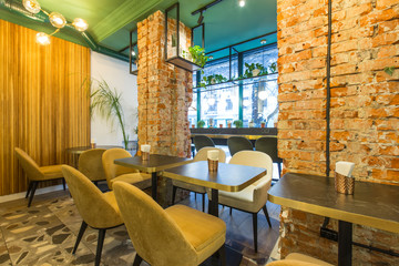 Loft Interior of restaurant with big window and walls of red bricks
