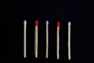1 Red matchstick outstanding form kindle matchstick in isolated background.