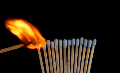 Roll of matchsticks has ignited, showing fired light up in isolated.