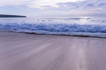 Surfing on the island of Bali in the Pacific and Indian Ocean. Male surfers engage in active sports on sick waves
