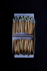 Grey match-box put in open shape and compared with kindled matchstick, place in isolated background.