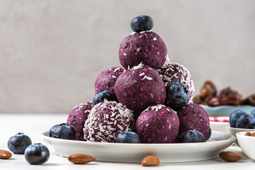 No bake blueberry and acai energy bites or balls, prepared with natural ingredients, such as nuts,...