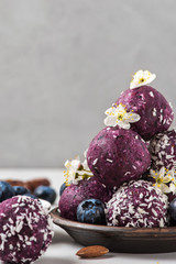 Healthy vegan dessert. Blueberry energy balls made of fresh berries, nuts and dates served with...