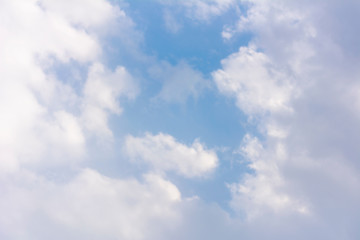 Natural sky. White gentle clouds around a bright blue sky. Wallpaper pastel tone, texture