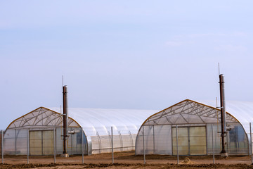 Exterior facade of a commercial greenhouse for growing vegetables in winter. Agriculture Development Concept.