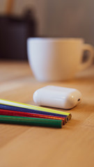 pens and pencils on a wooden desk