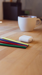 pens and pencils on a wooden desk