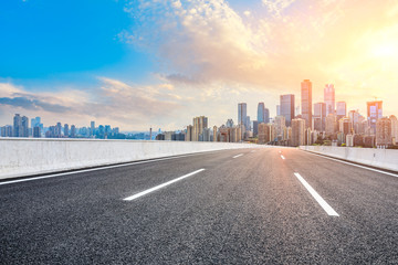 Fototapeta premium Empty asphalt road and Chongqing city skyline and buildings at sunset,China.