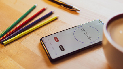 cup of coffee and pencil and mobile phone on a desk