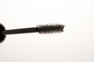 Close-up of a mascara brush with a white background