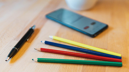 cup of coffee and pencil and mobile phone on a desk