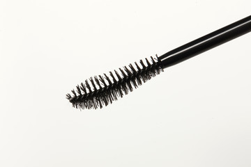 Close-up of a mascara brush with a white background